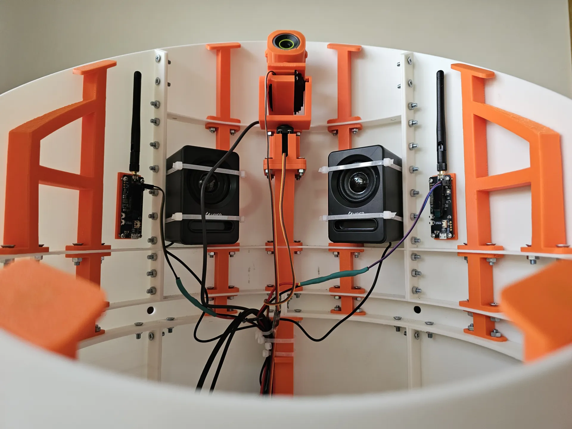 Head bay — 4K tracking camera on its printed gimbal, flanked by speakers and wireless modules